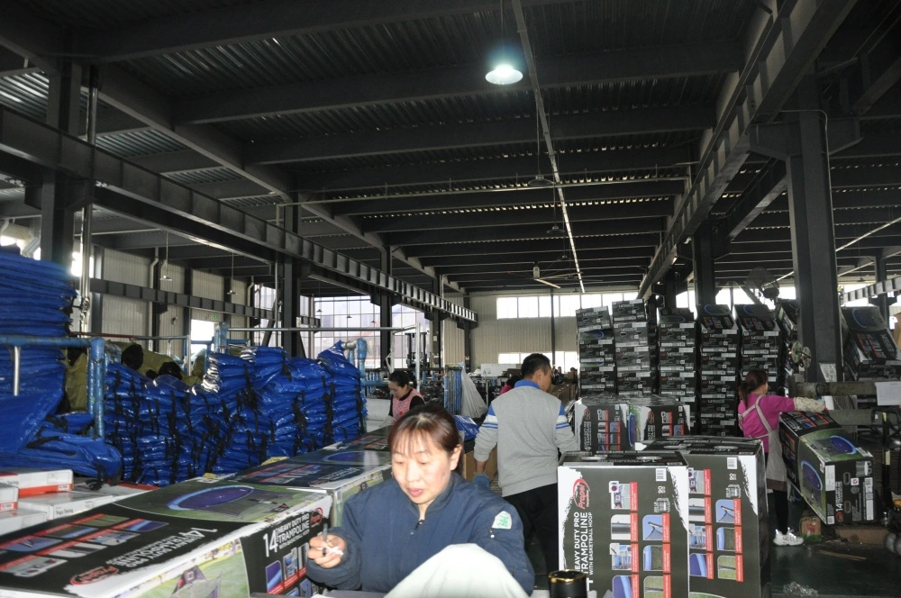 Trampoline Packaging Production Line Workers package trampoline boxes on automatic assembly production line